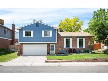 Charming two-story home featuring brick and siding, a well-maintained front yard, and a two-car garage at 11345 Marshall Ct, Westminster, CO 80020