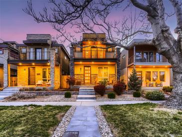 Charming three-story modern home with landscaped front yard at dusk at 3711 Mariposa St, Denver, CO 80211