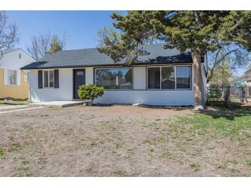 Charming single-story home featuring white brick, a well-maintained yard, and mature landscaping at 1675 N Wabash St, Denver, CO 80220