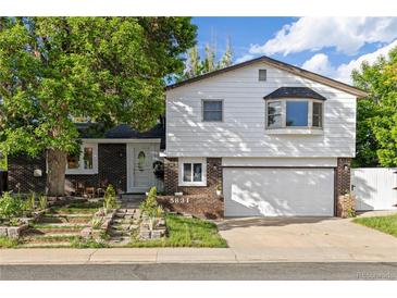 Charming two-story home with a brick and siding exterior, plus a two car garage and front yard at 5831 W 108Th Pl, Westminster, CO 80020