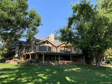Expansive deck and lush backyard create a perfect outdoor oasis for entertaining and relaxation at 4133 Niblick Dr, Longmont, CO 80503