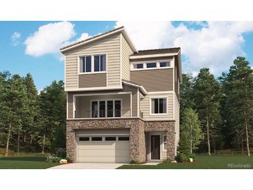 Charming two-story home with stone accents, a front balcony, and an attached two-car garage at 9135 White Ridge Rd, Englewood, CO 80112