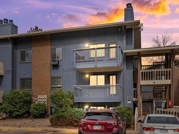 Charming condo exterior with two balconies, well-maintained landscaping, and brick accents at sunset at 2800 Kalmia Ave # A310, Boulder, CO 80301