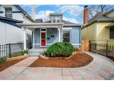 Charming home with well-maintained landscaping, red door, stone pathway, and inviting curb appeal at 161 W Maple Ave, Denver, CO 80223
