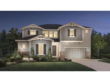 Charming two-story home with a gray exterior, lush landscaping, and a well-maintained front yard at 6289 Cristobal Pt, Parker, CO 80134