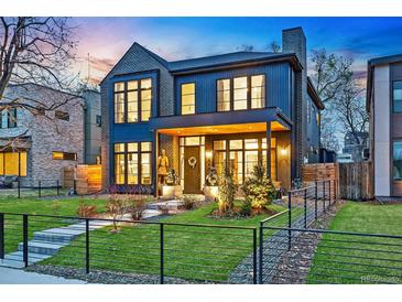 Stunning two-story home featuring a landscaped yard, modern architecture, and a welcoming front porch at 1130 S Cook St, Denver, CO 80210