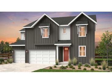 Charming two-story home featuring a modern farmhouse style with a red door and a well-manicured front yard at 16320 W 92Nd Cir, Arvada, CO 80007