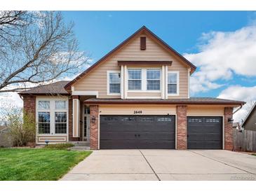 Charming two-story home features a well-maintained front yard and attached two car garage at 2649 S Kline Cir, Lakewood, CO 80227