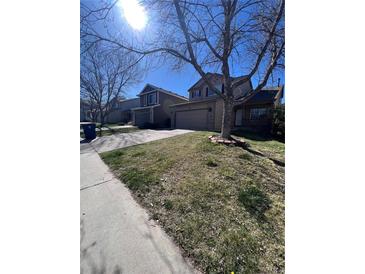 A charming suburban home is displayed with a well-maintained lawn and inviting curb appeal at 1062 Timbervale Trl, Highlands Ranch, CO 80129