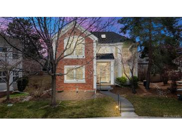 Charming brick two-story home with manicured front yard and inviting walkway at 1011 S Valentia St # 147, Denver, CO 80247