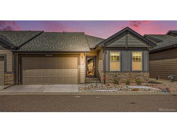 Charming single-Gathering home with a well-maintained two-car garage and stone-accented facade at 11791 Barrentine Loop, Parker, CO 80138