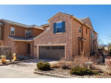 Charming two-story home featuring a stone exterior, well-maintained landscaping, and a convenient two-car garage at 9186 Viaggio Way, Highlands Ranch, CO 80126