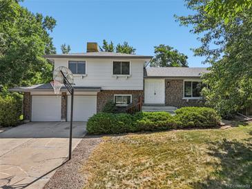 Charming two-story home with a brick facade, an attached two-car garage, and a well-maintained front yard at 7862 W 84Th Ct, Arvada, CO 80005
