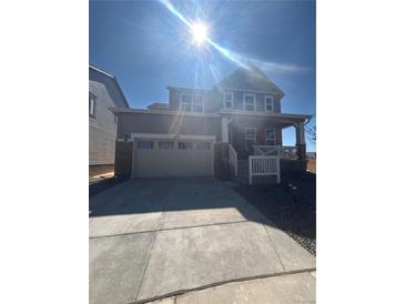 Charming two-story home with a two car garage and a welcoming front porch at 2184 S Gold Bug Ct, Aurora, CO 80018