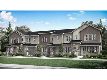 Attractive townhome exterior boasts a combination of stone and siding accents, plus well-maintained landscaping at 1967 S Haleyville Way, Aurora, CO 80018