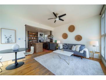 Inviting living space with modern decor, seamlessly connected to a stylish kitchen at 3735 Inca St, Denver, CO 80211
