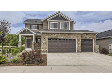 Beautiful two-story home featuring a three-car garage and stone accents at 4433 N Picadilly Ct, Aurora, CO 80019