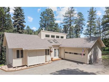 Charming single-Gathering home with a two-car garage and a well-maintained lawn surrounded by mature trees at 649 Cottonwood Dr, Evergreen, CO 80439