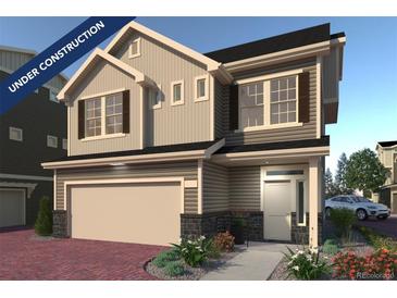 Under construction, this charming two-story home boasts neutral siding, shuttered windows, and an attached two-car garage at 16121 E 111Th Dr, Commerce City, CO 80022