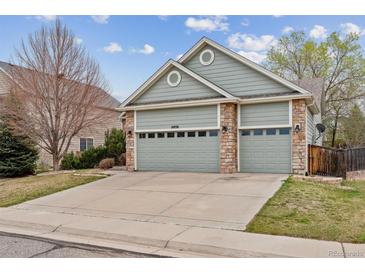 Inviting home featuring a three-car garage and a well-maintained lawn in a desirable neighborhood at 14938 Clayton St, Thornton, CO 80602