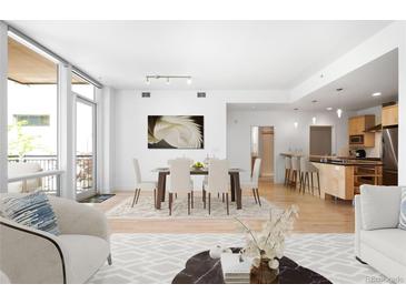 Bright living room featuring a dining area, an open floorplan, and floor-to-ceiling windows at 1401 Delgany St # 211, Denver, CO 80202