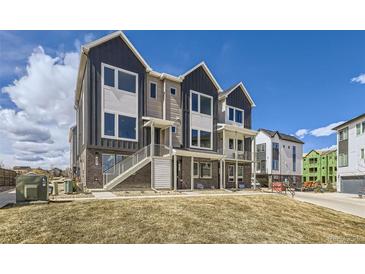 Beautiful townhome exterior featuring modern design, brick accents, and an inviting entrance on a sunny day at 657 Harness St, Erie, CO 80516