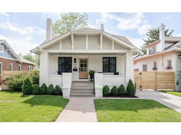 Charming home featuring a brick facade, covered porch, and well-manicured lawn at 4261 Julian St, Denver, CO 80211