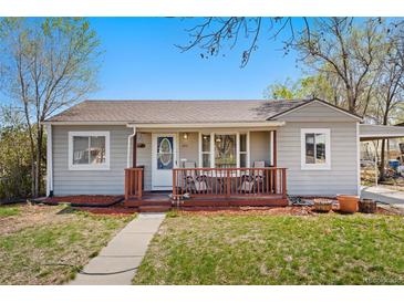 Charming home with a cozy front porch and well-maintained lawn on a sunny day at 640 S Quivas St, Denver, CO 80223