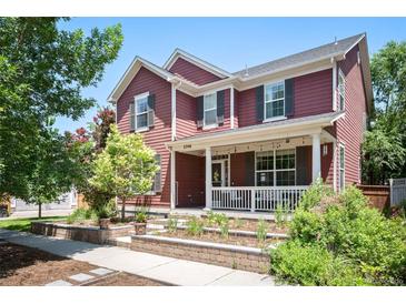 Charming two-story home featuring a welcoming front porch, complemented by a beautifully landscaped yard at 2746 Geneva St, Denver, CO 80238