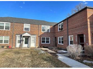 Charming brick townhomes featuring well-maintained lawns and inviting entrances at 2856 Jasmine St, Denver, CO 80207