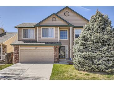 Charming two-story home featuring a two-car garage and well-maintained lawn at 237 Cherry St, Castle Rock, CO 80104