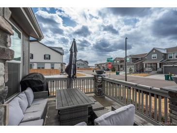 Inviting porch with comfortable seating area, offering a relaxing outdoor space at 688 N Bersshine Ct, Watkins, CO 80137