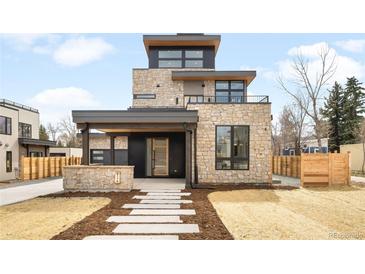 Modern stone facade with a covered front porch, balcony and contemporary design elements at 2170 Vine Ave, Boulder, CO 80304