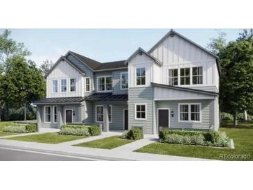 Charming two-story home featuring a modern design with gray and white color scheme, and well-manicured lawn at 6639 N Parterre Pkwy # 1, Thornton, CO 80602