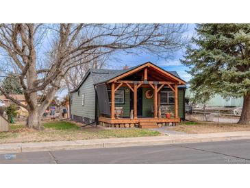 Charming home featuring a covered front porch with wood beam accents and ample outdoor seating at 329 2Nd St, Frederick, CO 80530