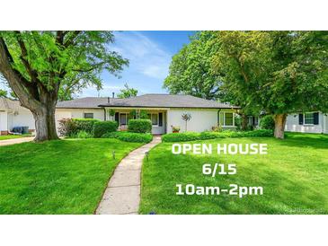 Charming single-story home with lush green lawn, walkway, and mature trees for an inviting curb appeal at 1935 Oneida St, Denver, CO 80220