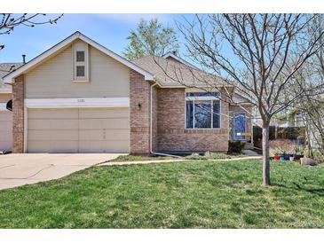 Charming single-Gathering home features a well-maintained front yard and an attached two-car garage at 1281 S Allison St, Lakewood, CO 80232