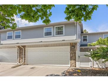 Charming townhome featuring stone accents, a spacious two-car garage, and a well-maintained front yard at 2742 S Xanadu Way, Aurora, CO 80014