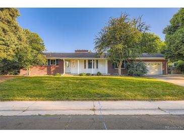 Charming brick home with a well-manicured lawn and mature trees in a desirable neighborhood at 5857 S Logan Ct, Centennial, CO 80121