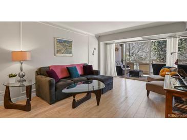 Cozy living area with a balcony view, modern furnishings, and natural light throughout at 800 N Washington St # 307, Denver, CO 80203