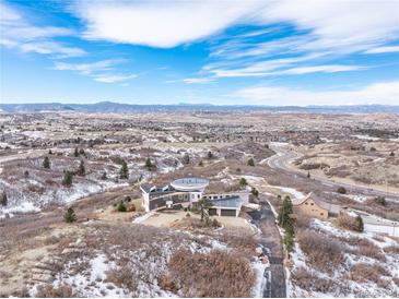 Modern home with circular roofline nestled on a hillside with scenic views at 1175 Ridge Oaks Dr, Castle Rock, CO 80104