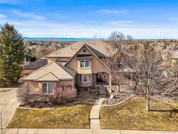 Charming single-Gathering home features a well-manicured lawn and a grand entrance with an arched doorway at 7035 S Picadilly St, Aurora, CO 80016