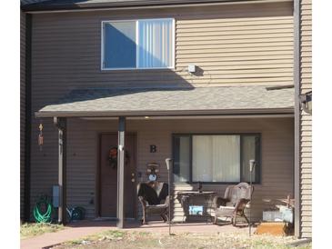 Inviting front porch with charming seating area offers a cozy welcome to this lovely home at 473 N Banner St # B, Elizabeth, CO 80107