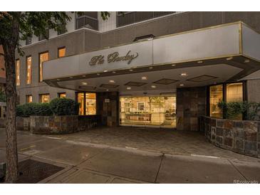 The Barclay building features stone accents, manicured landscaping, and covered entrance at 1625 Larimer St # 605, Denver, CO 80202