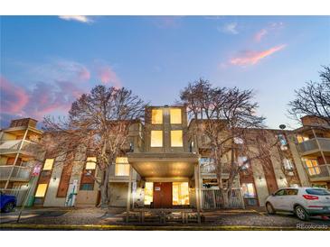 Exterior shot of building with multiple stories and front entrance, landscaping with trees, and multiple balconies at 1300 S Parker Rd # 9, Denver, CO 80231