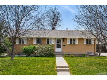 Charming single-story home featuring a well-maintained lawn and mature landscaping at 7751 S Race St, Centennial, CO 80122