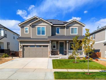 Charming two-story home with landscaped yard, solar panels, and an attached two-car garage at 821 Boulder Peak Ave, Erie, CO 80516