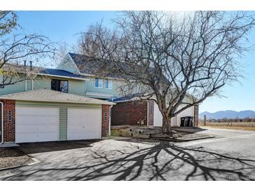 Charming townhouse with brick accents, an attached two-car garage, and well-maintained landscaping at 2030 Gyros Cir # 155, Lafayette, CO 80026