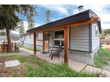 Charming home with a covered porch, rustic wood accents, and inviting curb appeal at 32 Magnum Bonum Dr, Breckenridge, CO 80424