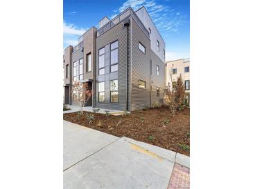Modern three-story home featuring steel siding and a brick facade, showcasing contemporary design and curb appeal at 5745 W 91St Ave, Westminster, CO 80031